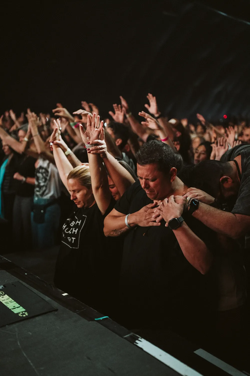 The congregation worshipping with hands raised