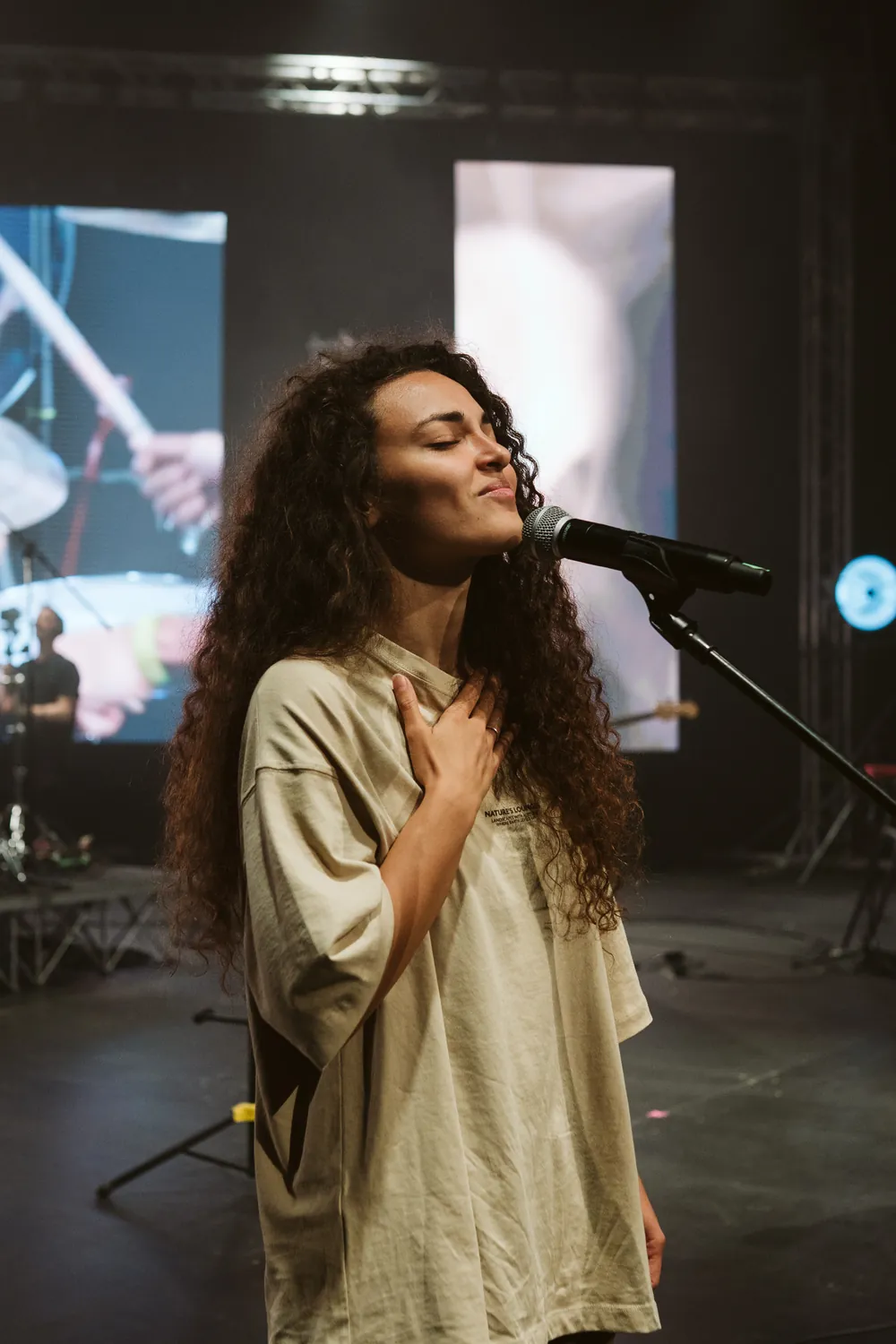 A woman praying with her hand on her heart